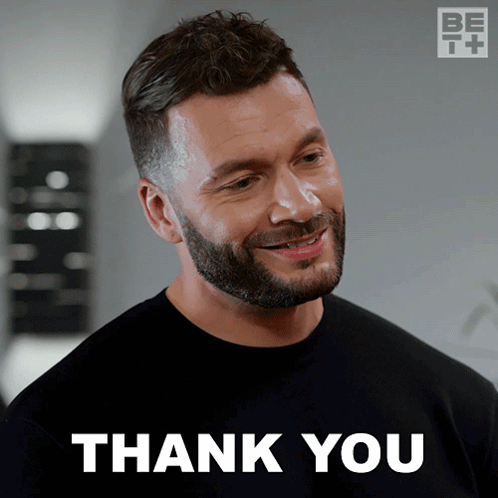 A Man With A Beard Is Smiling With The Words Thank You Behind Him GIF