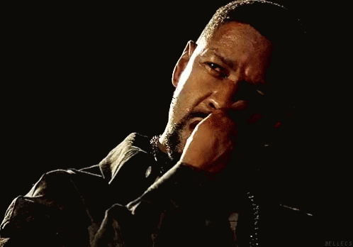 A Man With A Beard Is Smoking A Cigarette And Has Blood On His Shirt GIF