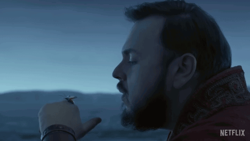 Bearded Man Smoking Cigarette In Front Of Sky GIF