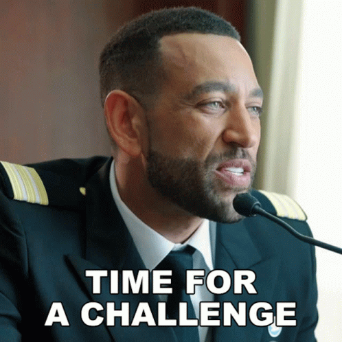 A Man With A Beard Is Speaking Into A Microphone With The Words Time For A Challenge Below Him GIF