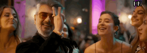 A Man With A Beard Is Standing In A Crowd Of People . GIF