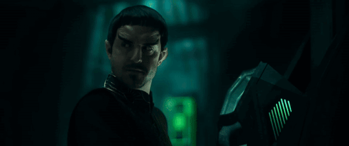 Bearded Man Standing In Dark Room With All According To Plan GIF