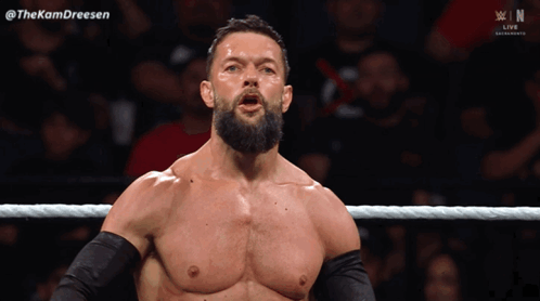 A Man With A Beard Is Standing In A Wrestling Ring With The Hashtag Thekamdreesen GIF