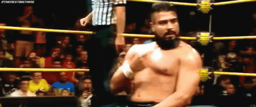 A Man With A Beard Is Standing In A Wrestling Ring Without A Shirt . GIF