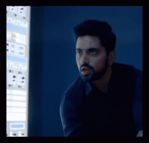 A Man With A Beard Is Standing In Front Of A Computer Screen That Says ' A ' On It GIF