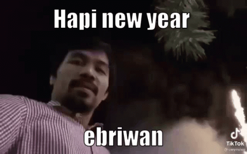 A Man With A Beard Is Standing In Front Of A Fireworks Display And Says Hapi New Year Ebriwan . GIF