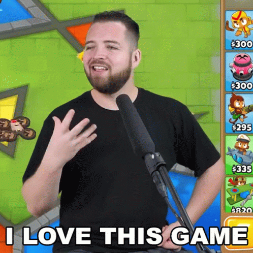 A Man With A Beard Is Standing In Front Of A Microphone And Says I Love This Game GIF
