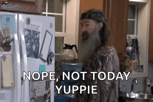 A Man With A Beard Is Standing In Front Of A Refrigerator With The Words Nope Not Today Yuppie On It GIF