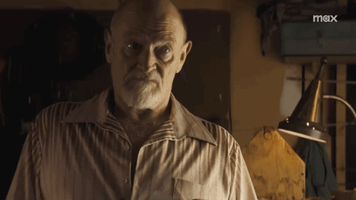 A Man With A Beard Is Standing In Front Of A Sign That Says Mox GIF