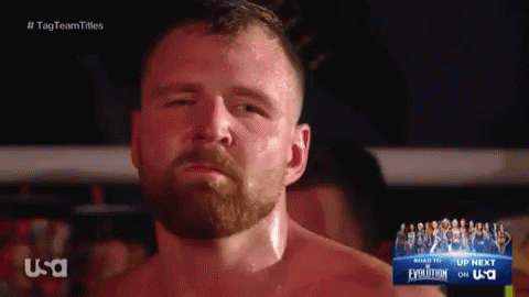 A Man With A Beard Is Standing In Front Of A Sign That Says Usa GIF