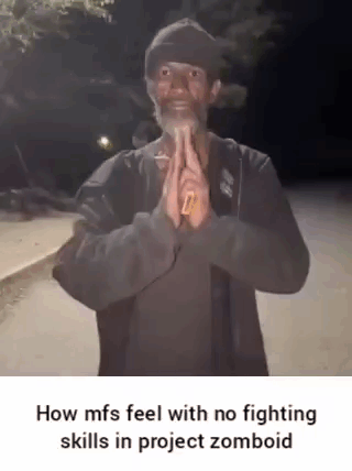 A Man With A Beard Is Standing In Front Of A Street With His Hands Folded In Prayer . GIF