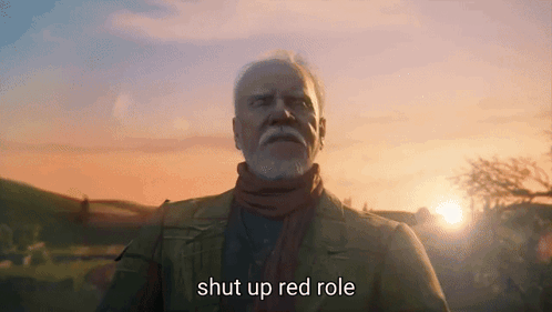 A Man With A Beard Is Standing In Front Of A Sunset And Says Shut Up Red Role GIF