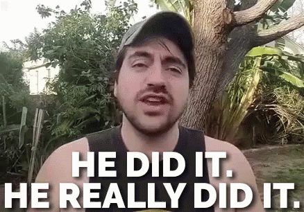 A Man With A Beard Is Standing In Front Of A Tree And Says He Did It He Really Did It . GIF