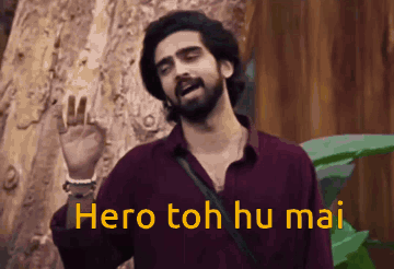 A Man With A Beard Is Standing In Front Of A Tree And Says Hero Toh Hu Mai . GIF
