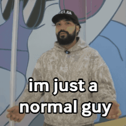 A Man With A Beard Is Standing In Front Of A Wall And Says " Im Just A Normal Guy " GIF