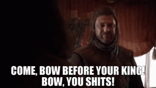 A Man With A Beard Is Standing In Front Of A Window And Talking To Another Man In A Room . GIF