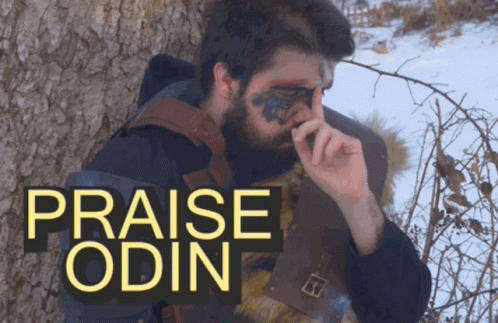 A Man With A Beard Is Standing Next To A Tree With The Words Praise Odin Written Above Him GIF
