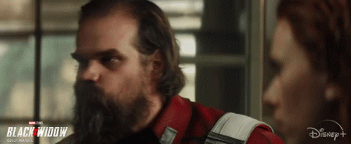 Man With Beard Next To Woman In Black Widow Ad GIF