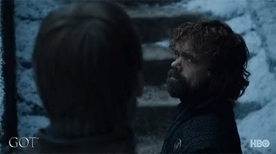 A Man With A Beard Is Standing Next To A Woman With The Word Got On The Bottom Of The Image GIF