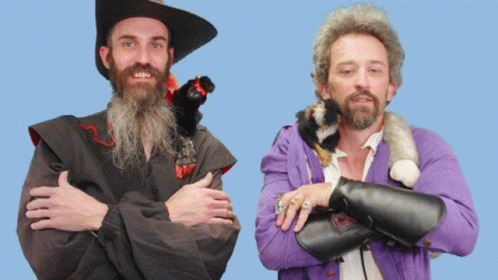A Man With A Beard Is Standing Next To Another Man With A Purple Jacket GIF