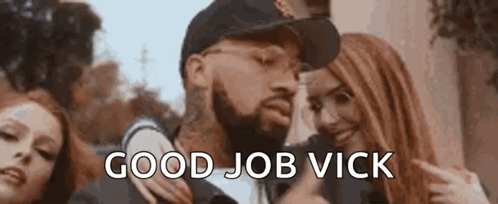 A Man With A Beard Is Standing Next To Two Women And Giving A Thumbs Up Sign . GIF