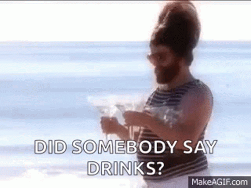 Bearded Man On Beach Holding Water Asking Did Somebody Say Drinks GIF