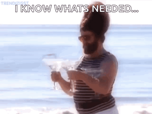Man With Beard On Beach Holding Wine Saying I Know What's Needed GIF