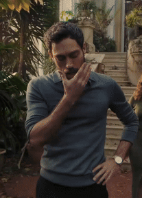 A Man With A Beard Is Standing With His Hands On His Hips And A Watch On His Wrist GIF