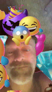 A Man With A Beard Is Surrounded By Balloons And Emojis GIF