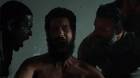 A Man With A Beard Is Surrounded By Two Other Men With Their Mouths Open GIF