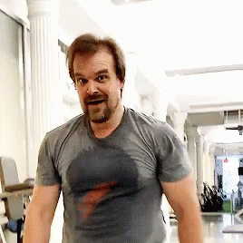 A Man With A Beard Is Sweating In A Gym While Wearing A T-Shirt . GIF