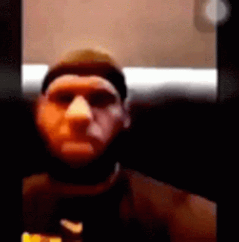 A Man With A Beard Is Taking A Selfie With A Camera . GIF