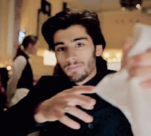 A Man With A Beard Is Taking A Selfie With His Phone GIF