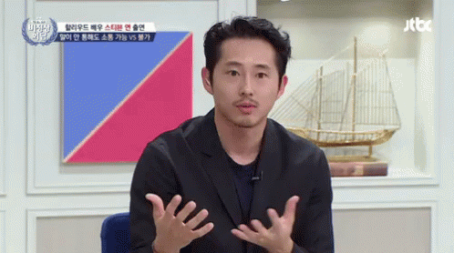 A Man With A Beard Is Talking In Front Of A Jtbc Sign GIF