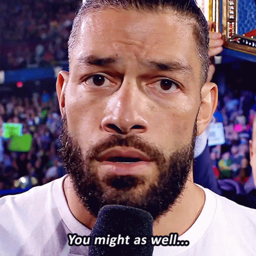 A Man With A Beard Is Talking Into A Microphone And The Words You Might As Well Are Above Him GIF