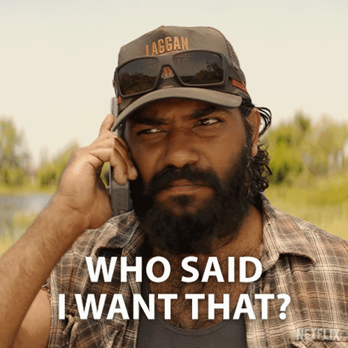 A Man With A Beard Is Talking On A Cell Phone With The Words Who Said I Want That Below Him GIF