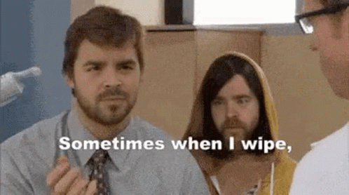A Man With A Beard Is Talking To A Doctor While Another Man In A Yellow Hoodie Looks On . GIF