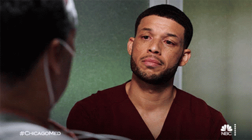 A Man With A Beard Is Talking To A Nurse With The Hashtag #Chicagomed On The Bottom GIF