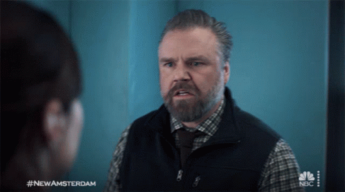 A Man With A Beard Is Talking To A Woman With #Newamsterdam On The Bottom GIF