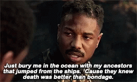 A Man With A Beard Is Talking To Another Man In A Movie Scene . GIF