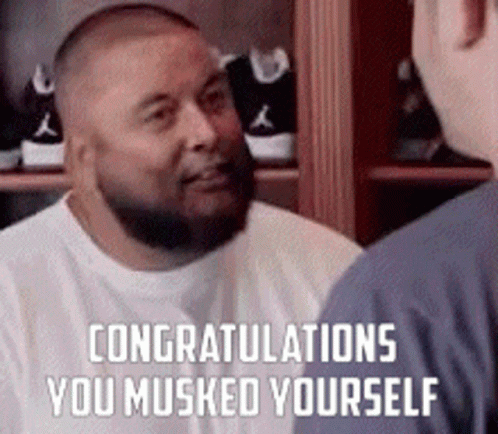 A Man With A Beard Is Talking To Another Man In Front Of A Closet . GIF