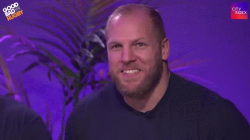 A Man With A Beard Is Waving His Hand And Saying Hi Mum . GIF