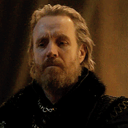 a man with a beard is wearing a black coat with a fur collar