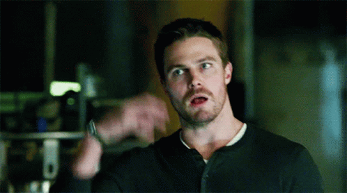 A Man With A Beard Is Wearing A Black Shirt GIF