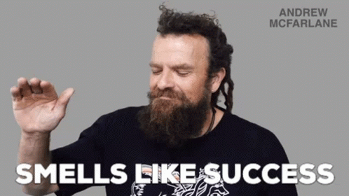 A Man With A Beard Is Wearing A Black Shirt That Says Andrew Mcfarlane GIF