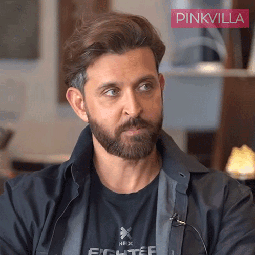 A Man With A Beard Is Wearing A Black Shirt That Says Fighter On It GIF