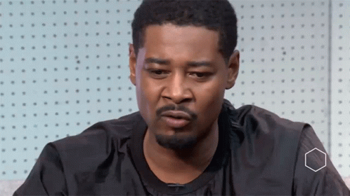 A Man With A Beard Is Wearing A Black Shirt That Says Nike GIF