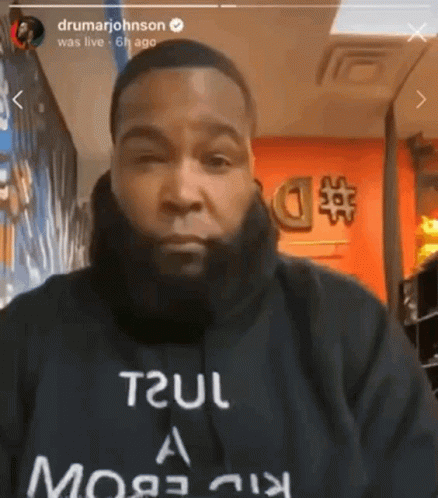 A Man With A Beard Is Wearing A Black Shirt That Says Trul GIF