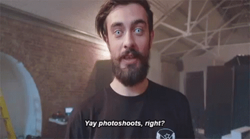 A Man With A Beard Is Wearing A Black Shirt That Says " Yay Photoshoots Right " . GIF