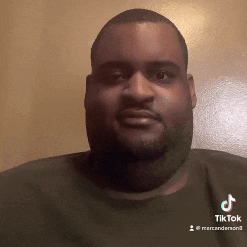 A Man With A Beard Is Wearing A Black Shirt With A Tiktok Logo On It GIF